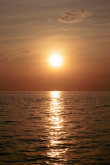 Sunset over the sea. The sun is reflected in the water.