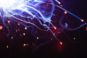 A bright flash of light and a sheaf of sparks in a cloud of smoke. Miniature Universe. Design...