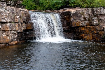 Serene waterfall cascading over rocky cliffside