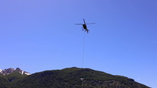 Mountain search and rescue operation in helicopter. Food delivery to remote mountain area.