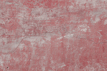 Red texture of a concrete wall with natural relief and damage in the form of chips and scratches. Fragment of an old stone surface with a crack. Dark rough surface with a place for an inscription