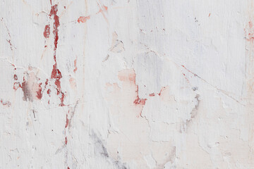 White texture of a concrete wall with natural relief and damage in the form of chips and scratches. Fragment of an old stone surface with a crack. Dark rough surface with a place for text.