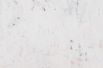 White texture of a concrete wall with natural relief and damage in the form of chips and scratches. Fragment of an old stone surface with a crack. Dark rough surface with a place for text.