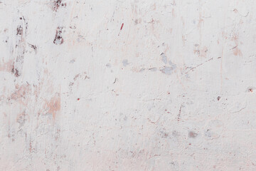 White texture of a concrete wall with natural relief and damage in the form of chips and scratches. Fragment of an old stone surface with a crack. Dark rough surface with a place for text.