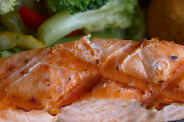  grill salmon served with fresh vegetables on a plate 