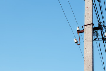 Overhead power lines. Telephone cable. Internet communications. An old post with a bunch of wires. Earth Day. Energy saving concept. The concept of saving electricity bills.
