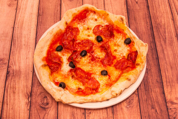 Margeritha the original pizza, it is characterized by its thin crust, slightly raised edges and a simple combination of tomato, mozzarella and basil.