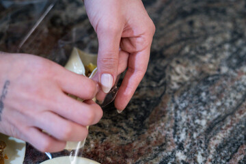 Femenine hands of a woman preparing emapanadas dumplings for baking