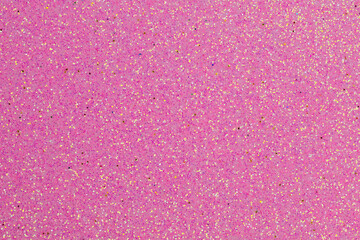 A pink background with glitter is displayed. The glitter is pink and gold, creating a shimmering...