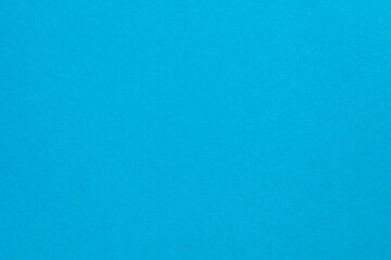 A blue background with a white dot in the middle, textured origami paper backdrop