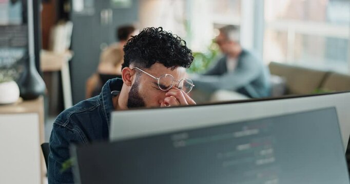 Tired, man and computer screen with headache in office for brain fog, website update and burnout. Worker, glasses and migraine with eye strain for IT programming, software development and fatigue