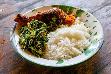 Indonesian dish. Rice with urap-urap (indonesian salad with chili, grated coconut and other spice) and roasted chicken