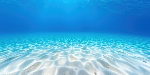 Underwater scene with deep blue sea, bright light rays, and sandy floor, background, sea life