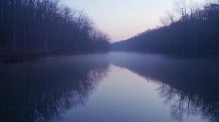 Fototapeta premium Tranquil Dawn: Misty River with Soft Swirling Mist and Faint Water Reflections