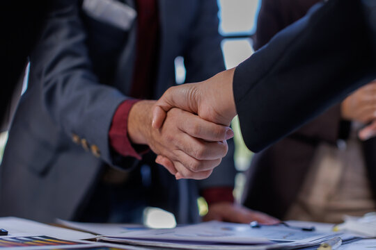 Business handshake for teamwork of business merger and acquisition,successful negotiate,hand shake,two businessman shake hand with partner to celebration partnership and business deal concept
