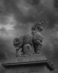 Majestic Stone Horse Sculpture Against Dramatic Cloudy Sky