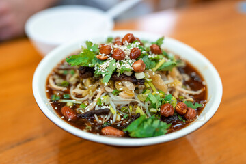Enjoy a Delicious Bowl of Spicy Noodle Salad, Complete with a Variety of Toppings