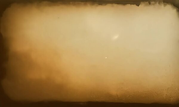 Blank old grunge paper overlay effect with a burnt edge and faded brown tones in the center. Seamless looping