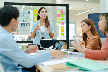 Group of young asian creative business brain storm meeting presentation,discussing roadmap to...