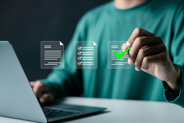Document management concept, project approve. Person using laptop to paperless online approval for...