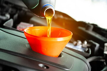 Refueling and pouring oil quality into the engine motor car Transmission and Maintenance Gear...