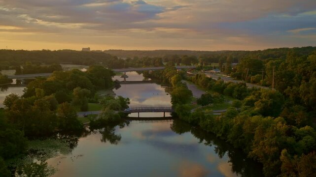 Drone footage with a slow, sweeping view of the Huron River in Ann Arbor, Michigan, in summer.