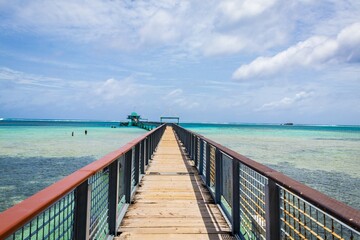 Scenic Wooden Pier Leading to Turquoise Waters and Horizon, Guam © Bossa Art