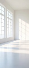 Sunlit Minimalism: A clean, airy, and modern room bathed in sunlight, showcasing a large window with soft, diffused light casting long shadows across the pristine floor. Ideal for showcasing products.