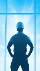Fototapeta premium Architect's Vision: A silhouette of a construction worker, viewed from behind, stands confidently before a bright, expansive window, gazing towards a hopeful future. The image evokes ambition.