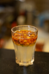 A close up shot of a glass with lemon tea