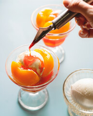 ice cream with peach with hand 