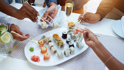 Hands, sushi and friends with chopsticks at restaurant for lunch, reunion and above with catering service at event. People, group and plate with food, fish and circle at party, diner or brunch