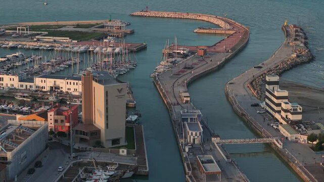 Aerial view of wharf and marina with boats in golden hour, Senigallia, Italy