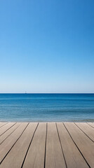 A serene view of a calm ocean from a wooden deck on a clear sunny day at the beach