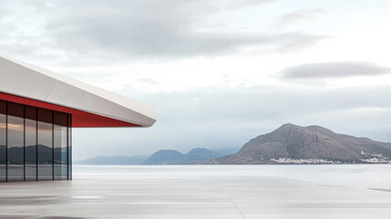 Fototapeta premium Modern architectural design overlooks a tranquil body of water with mountains in the background