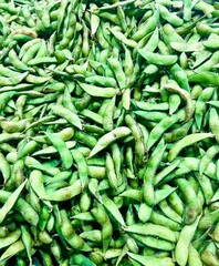 Photo of a group of edamame beans in a container that can be used as a background