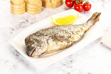 Baked Dorado fish served lemon