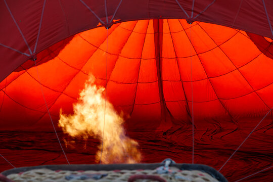 A hot air balloon with a fire in the bottom of it