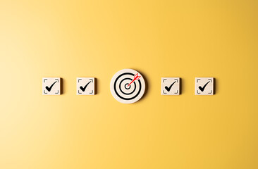 Target strategy, Task list, Checklist, Quality Control, Survey assessment to reach goals achievements in business success. To do lists for achieving target. Check mark and dartboard on wooden blocks.