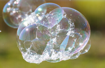 A bubble is floating in the air with a rainbow inside