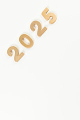 2025 Happy New Year. Top view of gold numbers on white background. Copy space, flat lay.