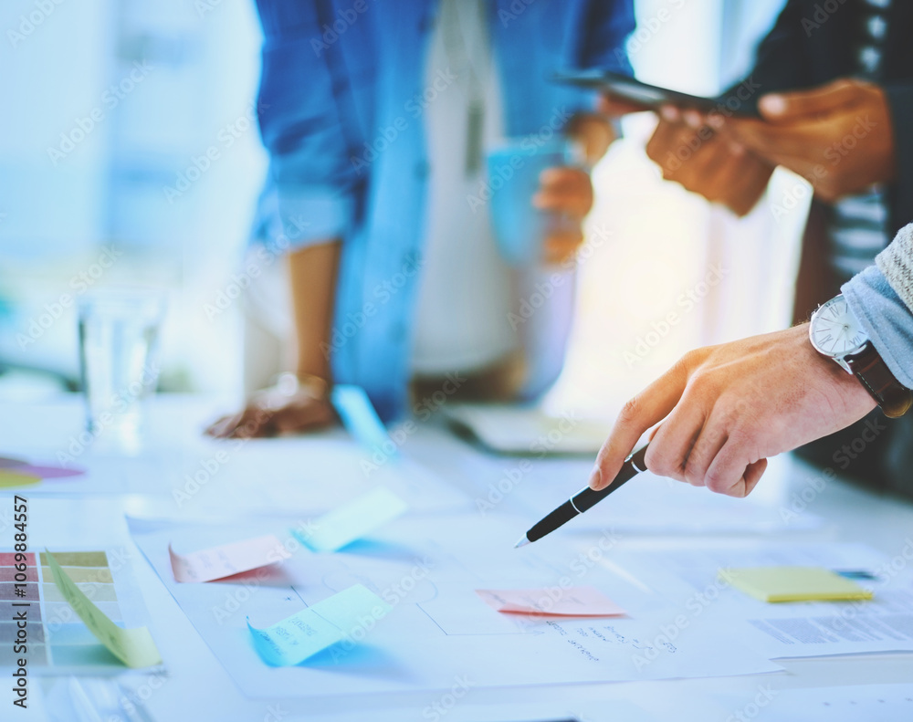 Poster Hand, business people and pointing at documents for strategy with pen in meeting. Group, paperwork and project manager planning with sticky note, brainstorming ideas and teamwork in creative startup