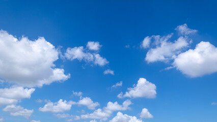 Fototapeta premium clear blue sky background,clouds with background, Blue sky background with tiny clouds. White fluffy clouds in the blue sky. 