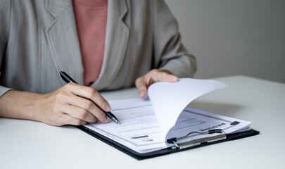 Executive CEO businesswoman checking job applicant documents resumes, interviews, and signing to approve the contract in the office room