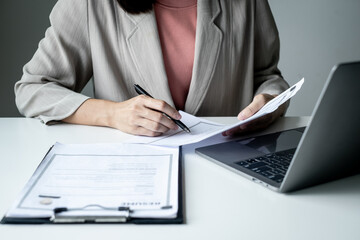 Executive CEO businesswoman checking job applicant documents resumes, interviews, and signing to approve the contract in the office room