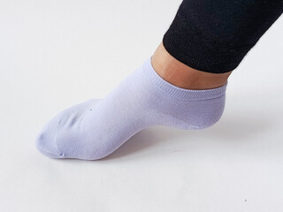 Blue sock on a woman's leg in black leggings. Sock size. Advertising background, space for text.