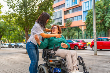 Asian caregiver hugging happily to a woman with disability outdoors