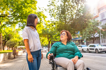 Woman with special needs and caregiver talking in the street