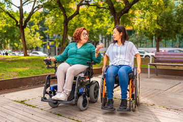 Cheerful friends with disability talking in a park
