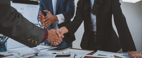 Holding hands, agreeing to invest in business together Colleagues clapping congratulations in the...